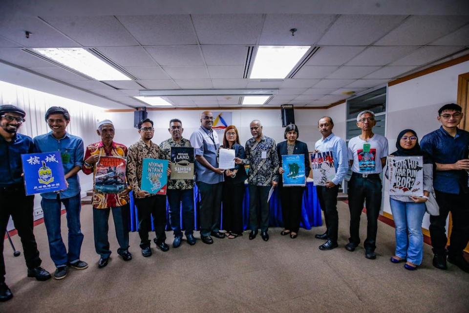 Penang Forum committee member, Khoo Salma Nasution, gives a copy of the Penang Tolak Tambak memorandum to Suhakam commissioner Jerald Joseph in Kuala Lumpur January 16, 2020. — Picture by Hari Anggara