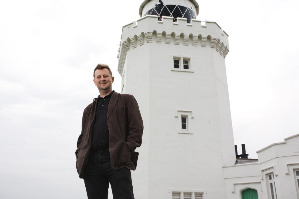 This undated photo made available Monday Aug. 20, 2012 by the National Trust shows Julian Baggini at the South Foreland Lighthouse, Dover, southern England. Philosopher Julian Baggini has a high-altitude new assignment _ pondering the significance and symbolism of the White Cliffs of Dover. The National Trust, guardian of the landmarks on England's south cast, has appointed Baggini the cliffs' first writer in residence. Starting Monday Aug. 20, 2012, he will spend a week living in a cliff-top lighthouse. Baggini said he hoped to learn “what the white cliffs of Dover mean for British people, including those for whom the cliffs were the first sight of the country which would become their adopted home." (AP Photo/Tim Stubbings/National Trust/PA Wire)