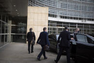 Britain's chief negotiator David Frost, center, leaves EU headquarters after a meeting with EU chief negotiator Michel Barnier in Brussels, Sunday, Dec. 20, 2020. The EU and the United Kingdom were still working Sunday on a "last attempt" to clinch a post-Brexit trade deal, with EU fishing rights in British waters the most notable remaining obstacle to avoid a chaotic and costly changeover on New Year. (AP Photo/Virginia Mayo)
