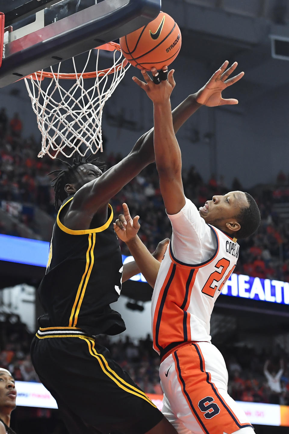 Syracuse guard Quadir Copeland, right, drives to the basket against Pittsburgh center Federiko Federiko during the second half of an NCAA college basketball game in Syracuse, N.Y., Saturday, Dec. 30, 2023. (AP Photo/Adrian Kraus)