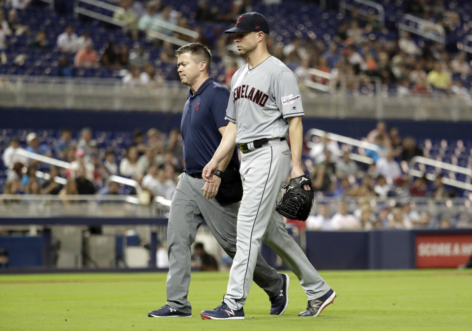 Cleveland Indians starting pitcher Corey Kluber, right, leaves during the fifth inning of the team’s baseball game against the Miami Marlins, Wednesday, May 1, 2019, in Miami. Kluber was hit by a single hit by Marlins’ Brian Anderson. (AP Photo/Lynne Sladky)