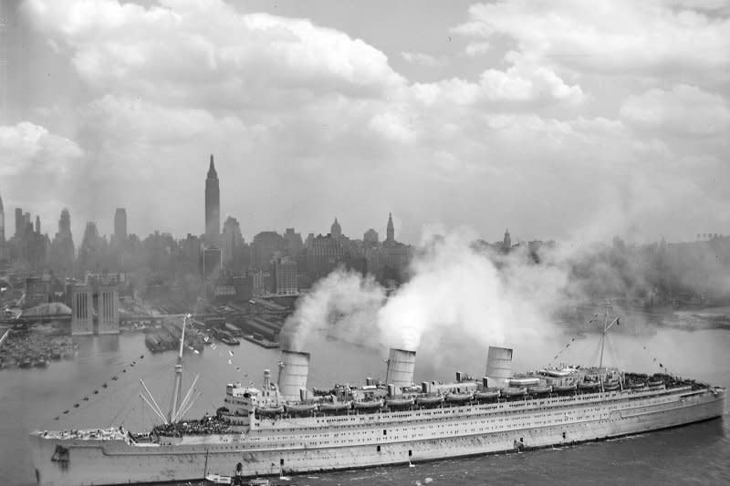 The British liner RMS Queen Mary arrives in New York harbor on June 20, 1945, with thousands of U.S. troops from Europe. On September 26, 1934, Britain's Queen Mary bestowed her name on Cunard-White Star Line's newest ocean liner in a christening ceremony in Scotland. File Photo courtesy U.S. Navy