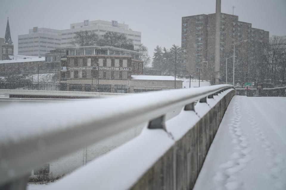 The Southeastern Glass Company building is seen from the snow-covered Oak Street Bridge in Knoxville on Jan. 15.