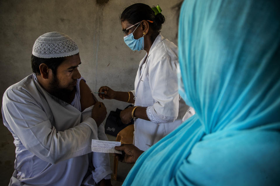 A health worker administers the vaccine for COVID-19 in Khola Bhuyan village on the outskirts of Gauhati, India, Tuesday, Sept. 7, 2021. (AP Photo/Anupam Nath)
