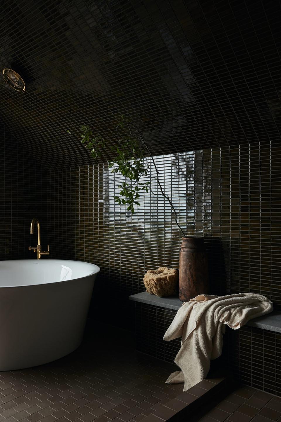 Brown green tile in bathroom with tub