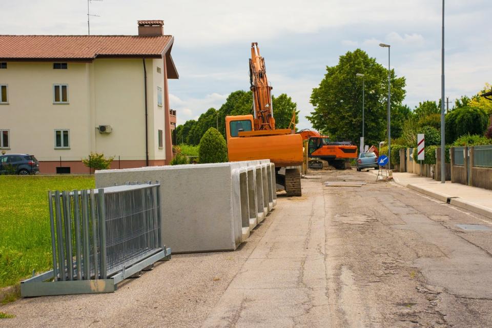 Temporary fence materials are seen ready to be put together on a dirt road.