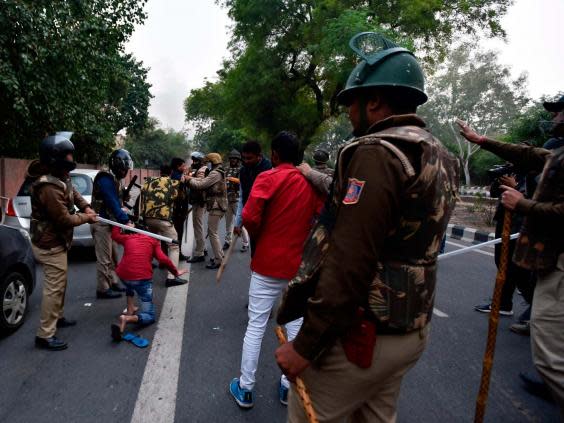 Police clash with demonstrators in New Delhi (STR/AFP via Getty Images)