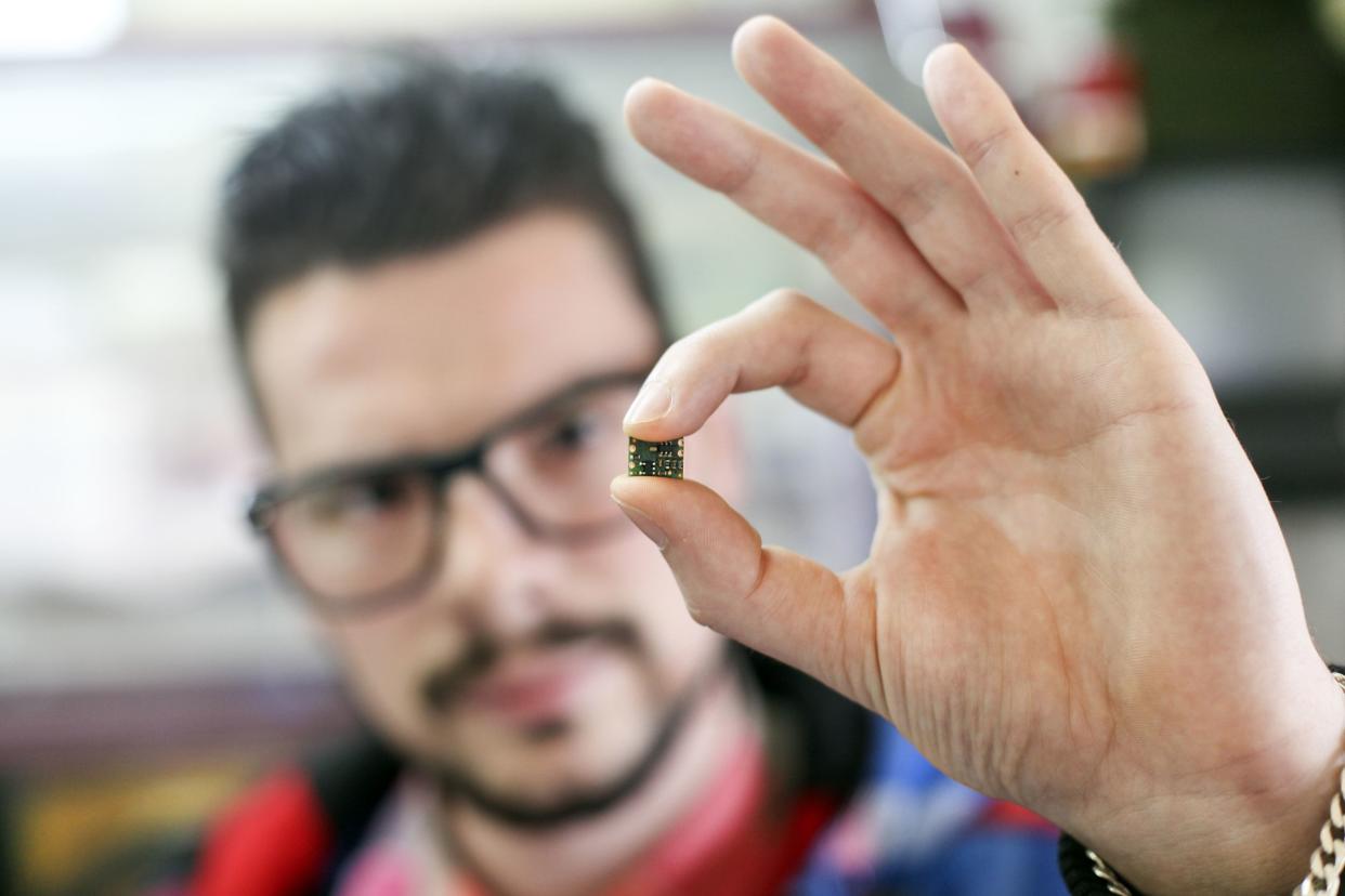man holding microchip
