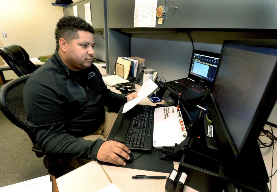 Springfield Police Det. Devin Schluter of the criminal investigation division works on a case at his desk on Thursday, January 25, 2024.