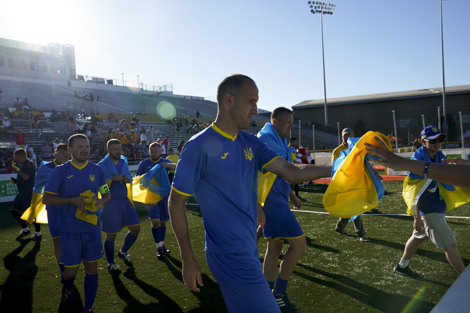 Ukraine players take the field for a match against Poland at the Homeless World Cup, Tuesday, July 11, 2023, in Sacramento, Calif. (AP Photo/Godofredo A. Vásquez)