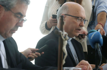 General secretary of the Chilean Episcopal Conference, monsignor Fernando Ramos, reads for the media the Pope Francis' letter stating, that the pope may summon Chile's bishops to Rome for a meeting on the country's sexual abuse crisis, in Punta de Tralca, Chile, April 11, 2018. REUTERS/Stringer