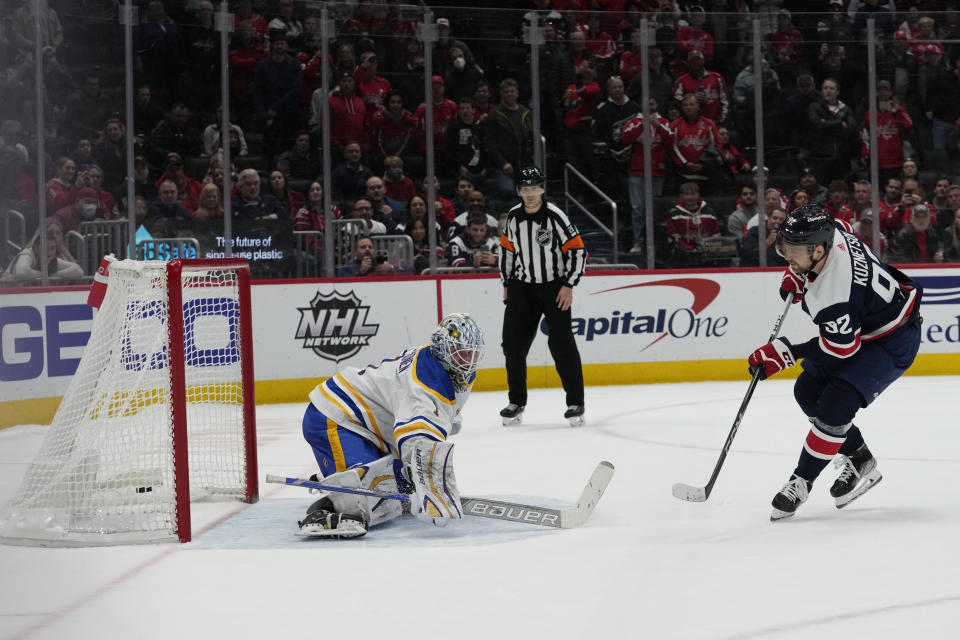 Washington Capitals center Evgeny Kuznetsov (92) scores against Buffalo Sabres goaltender Ukko-Pekka Luukkonen (1) during a shootout of an NHL hockey game Wednesday, March 15, 2023, in Washington. The Capitals won 5-4. (AP Photo/Carolyn Kaster)