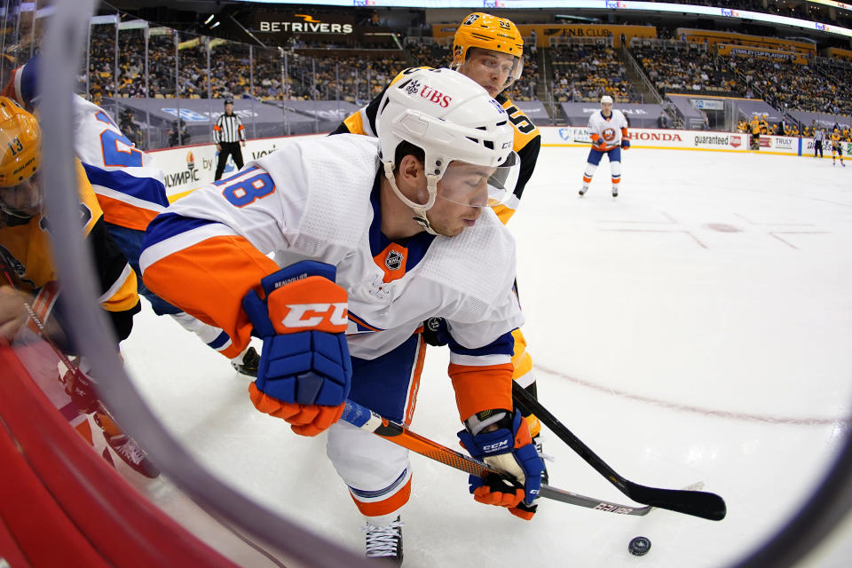 Pittsburgh Penguins' Teddy Blueger (53) checks New York Islanders' Anthony Beauvillier (18) during the second period in Game 2 of an NHL hockey Stanley Cup first-round playoff series in Pittsburgh, Tuesday, May 18, 2021. (AP Photo/Gene J. Puskar)