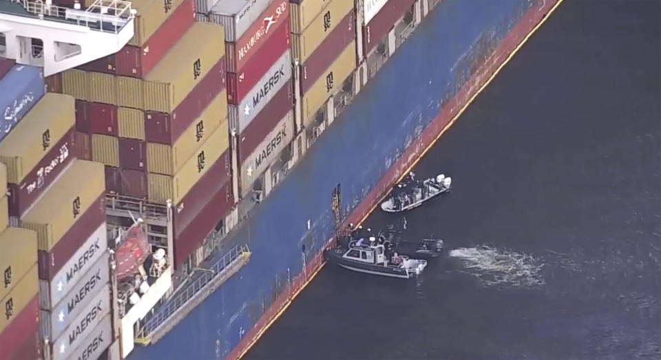 FBI agents get on board the cargo ship Dali on Monday, April 15, 2024 in Baltimore. The FBI is conducting a criminal investigation into the deadly collapse of the Francis Scott Key Bridge that is focused on the circumstances leading up to it and whether all federal laws were followed, according to someone familiar with the matter. (WJLA via AP)