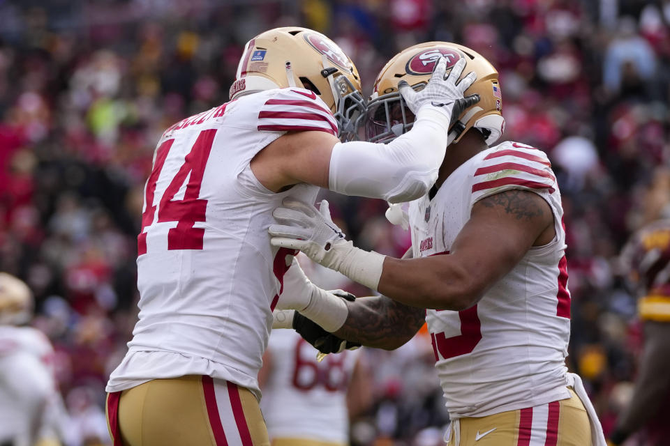 San Francisco 49ers running back Elijah Mitchell (25) celebrating his touchdown against the Washington Commanders with San Francisco 49ers fullback Kyle Juszczyk (44) during the second half of an NFL football game, Sunday, Dec. 31, 2023, in Landover, Md. (AP Photo/Alex Brandon)