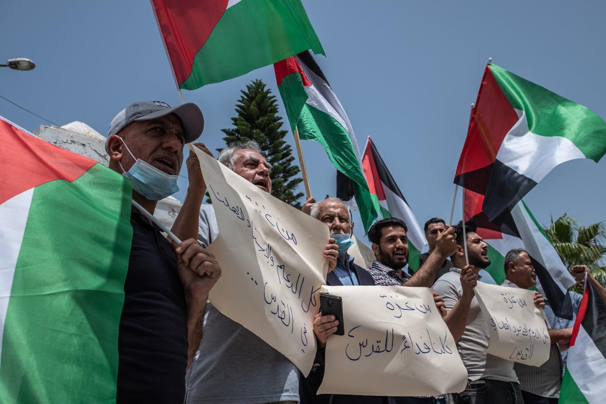 <p>Palestinians protest in Gaza following Israeli evictions in Jerusalem.</p> (Getty Images)