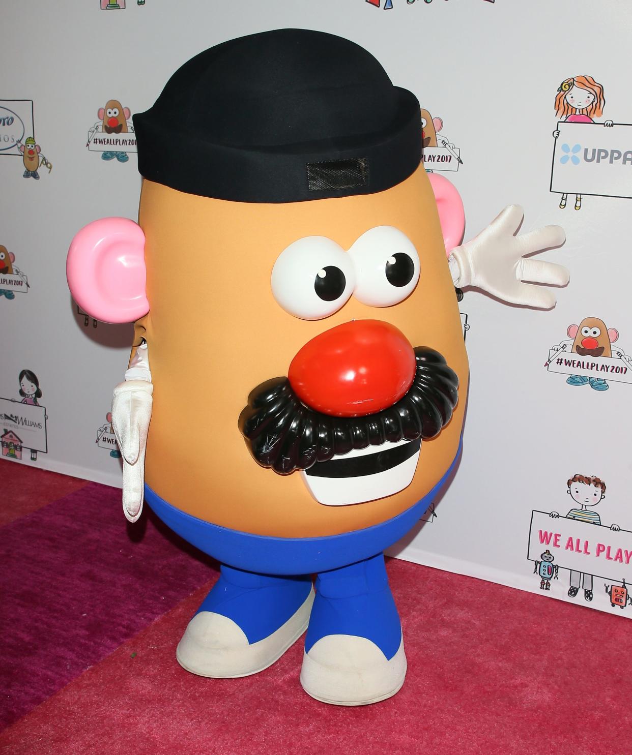 Potato Head attends the Zimmer Children's Museum Event in Los Angeles, he is looking towards the right, standing on a red carpet with a advertising on white background, 2017