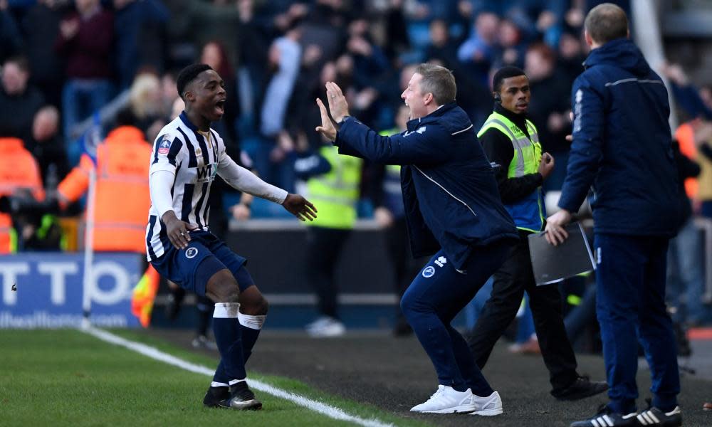 Millwall manager Neil Harris celebrates their late winner against Leicester City with Fred Onyedinma