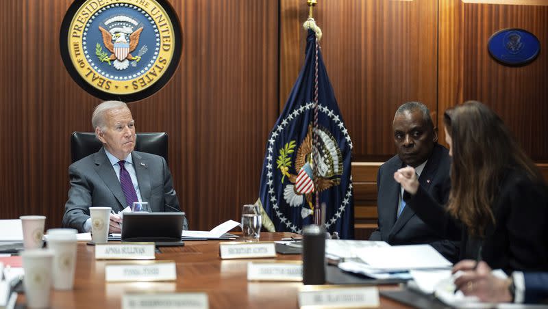 President Joe Biden receives the Presidential Daily Briefing on Monday, Jan. 29, 2024, in the White House Situation Room at the White House in Washington, as Defense Secretary Lloyd Austin listens.