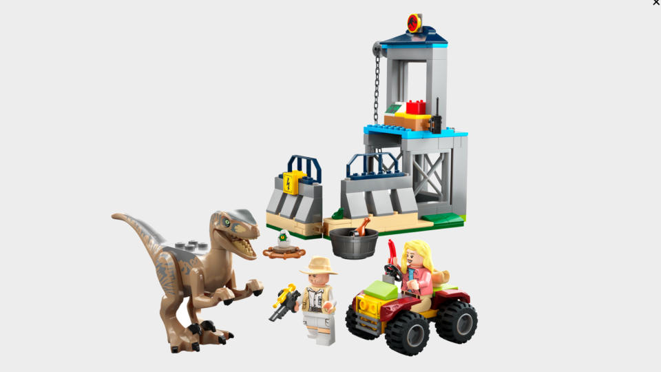 Lego Velociraptor Escape set on a plain background
