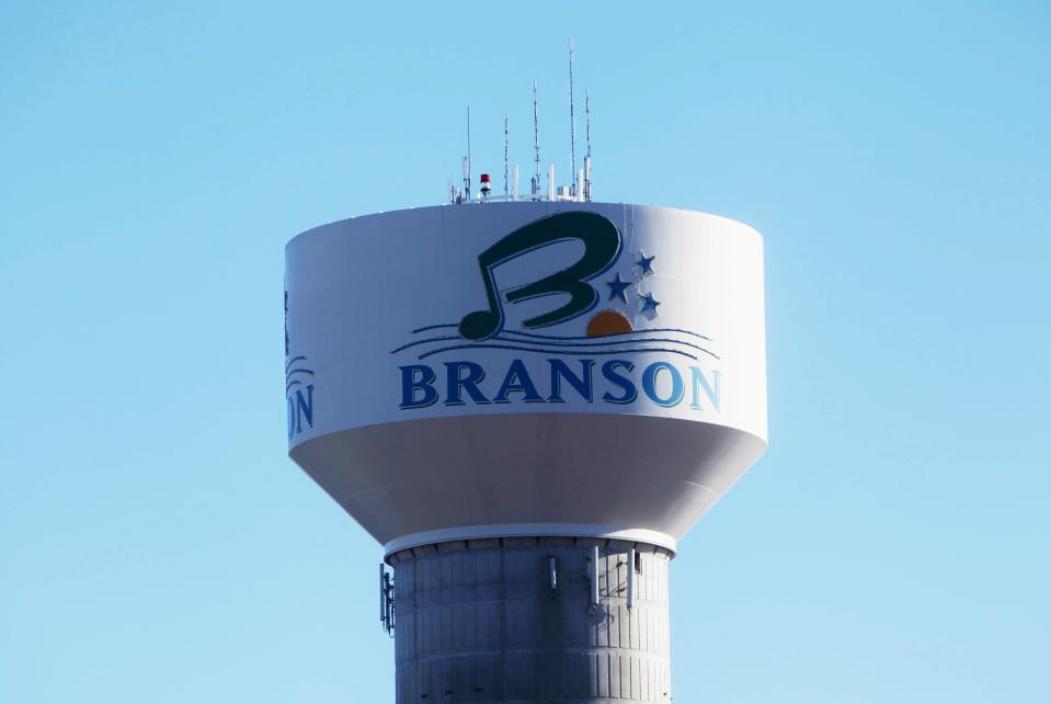 A water tower in Branson, Missouri shows a promotional logo for the tourism hub.