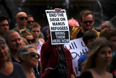 Refugee advocates hold placards as they participate in a protest in Sydney, Australia, against the treatment of asylum-seekers at Australia-run detention centres located at Nauru and Manus Island, November 18, 2017.      REUTERS/David Gray