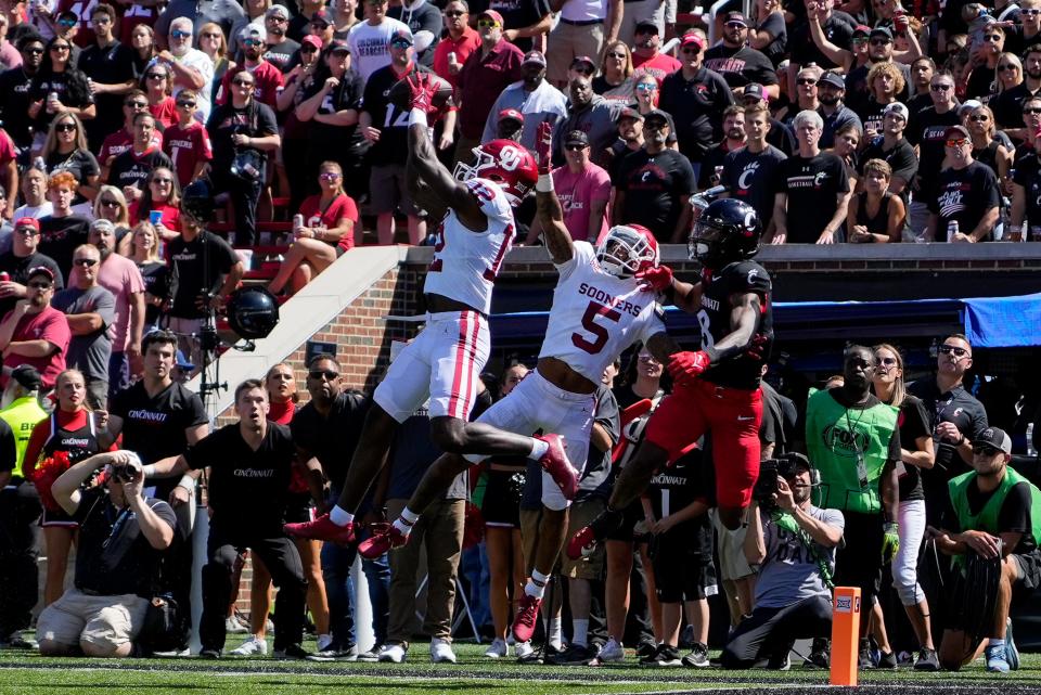 Oklahoma Sooners defensive back Key Lawrence (12) intercepts a pass intended for Cincinnati Bearcats wide receiver Evan Prater (3) in the second quarter of the NCAA Big 12 football game between the Cincinnati Bearcats and the Oklahoma Sooners at Nippert Stadium in Cincinnati on Saturday, Sept. 23, 2023.