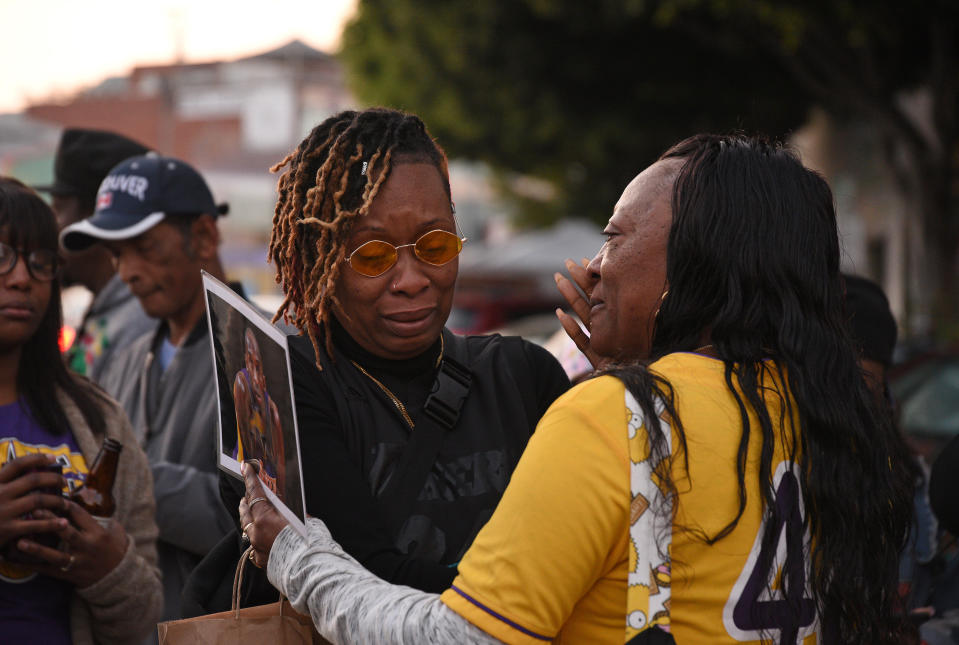 LOS ANGELES, CALIFORNIA - JANUARY 26: Distraught Los Angeles Lakers fan Naima Smith (wearing glasses) crying at a vigil for the late NBA star Kobe Bryant on January 26, 2020 in Los Angeles, California. (Photo by Michael Tullberg/Getty Images)