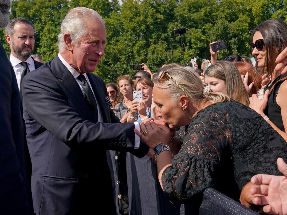 king charles woman kisses hand