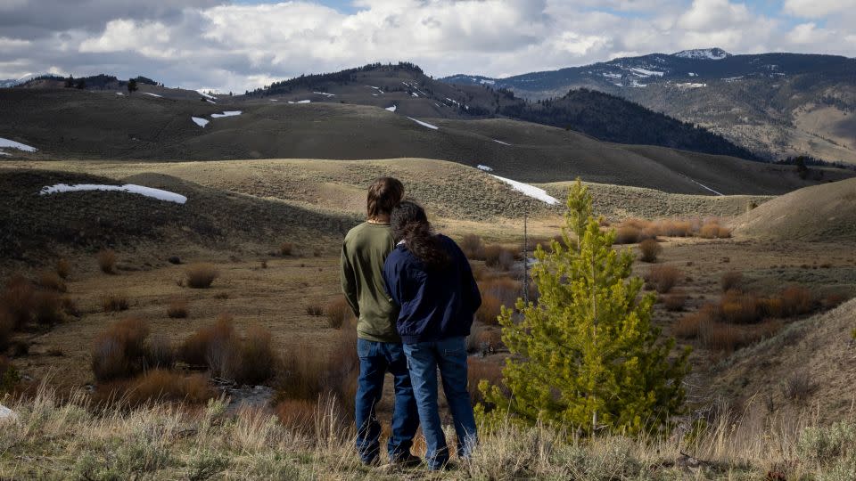 A couple looks at Crevice Mountain in Yellowstone National Park. The area is known as a good place to see wolves. - Natalie Behring/The Washington Post/Getty Images