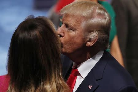 Republican U.S. presidential nominee Donald Trump kisses his wife Melania at the end of his debate against Democratic U.S. presidential nominee Hillary Clinton at Washington University in St. Louis, Missouri, U.S., October 9, 2016. REUTERS/Lucy Nicholson