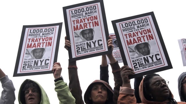 Protesters holding up posters of Trayvon Martin