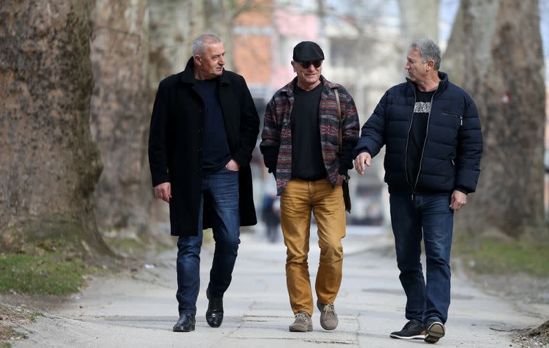 War veterans Marko Zelic (L-R), Rizo Salkic and Boro Jevtic walk through a park in Maglaj