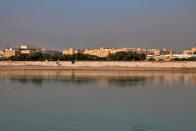 FILE - In this Friday, Jan. 3, 2020, file photo, U.S. Embassy is seen from across the Tigris River in Baghdad, Iraq. Iran has had its fingers in Iraq's politics for years, but the U.S. killing of an Iranian general and Iraqi militia commander outside Baghdad has added new impetus to the effort, stoking anti-Americanism that Tehran now hopes it can exploit to help realize the goal of getting U.S. troops out of the country. (AP Photo/Khalid Mohammed, File)