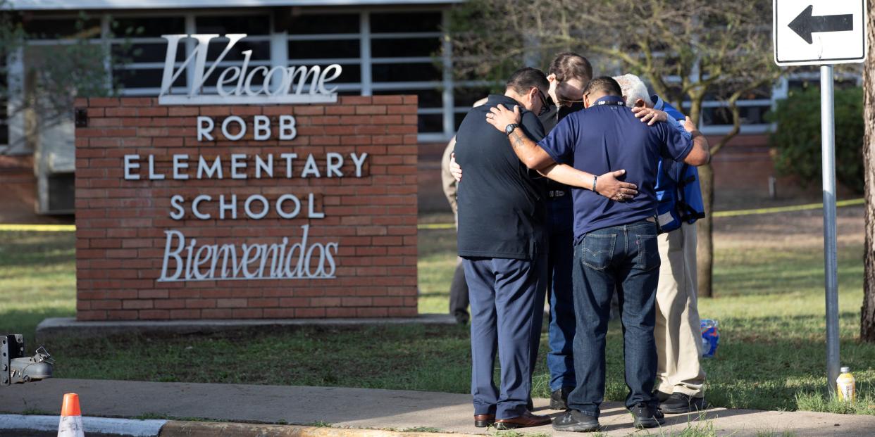 People gather at Robb Elementary School, the scene of a mass shooting in Uvalde, Texas, U.S. May 25, 2022.