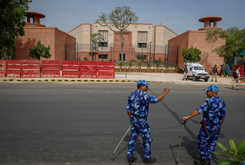 Policemen stand guard outside the India's new parliament building before its inauguration in New Delhi