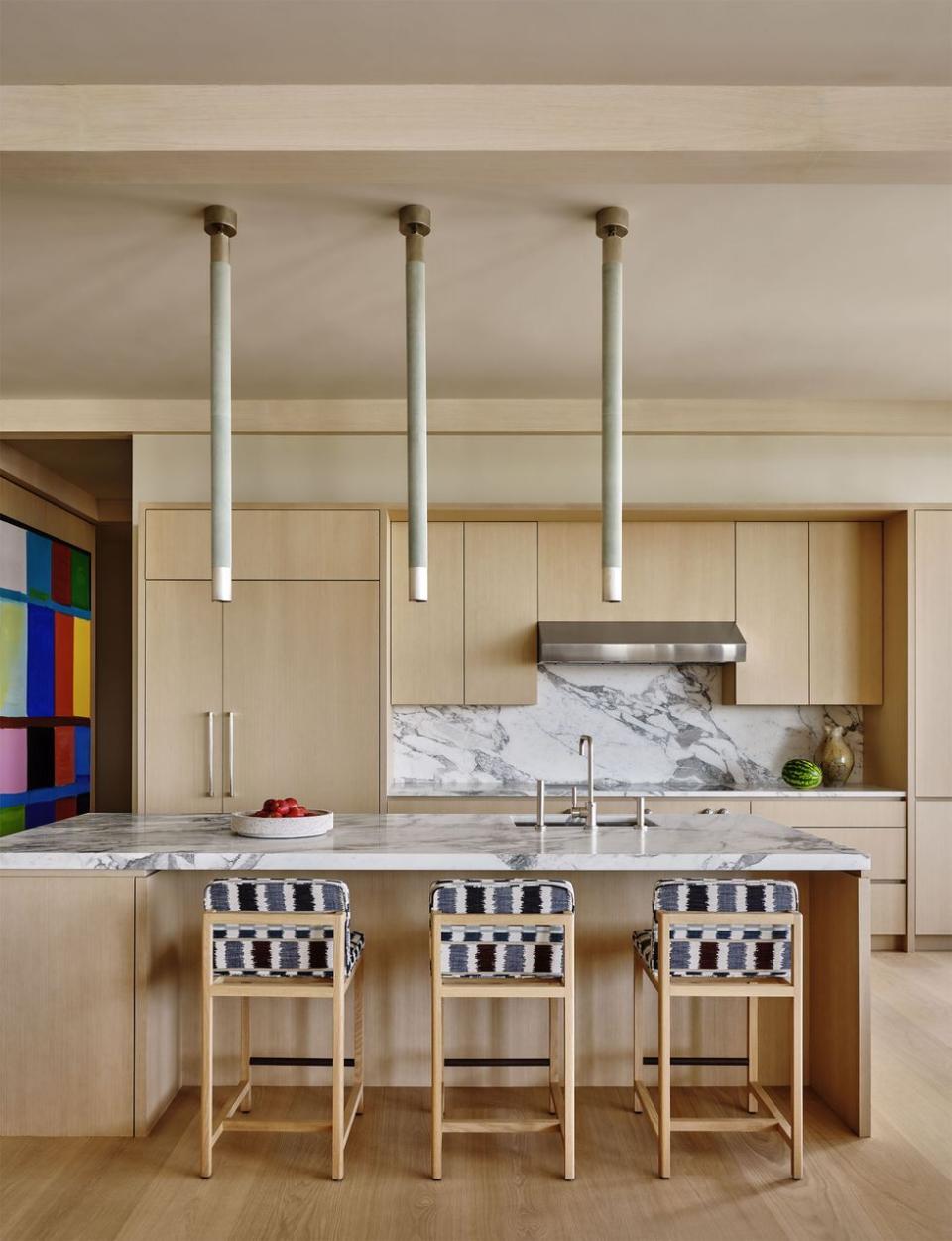 a kitchen with a bar and stools