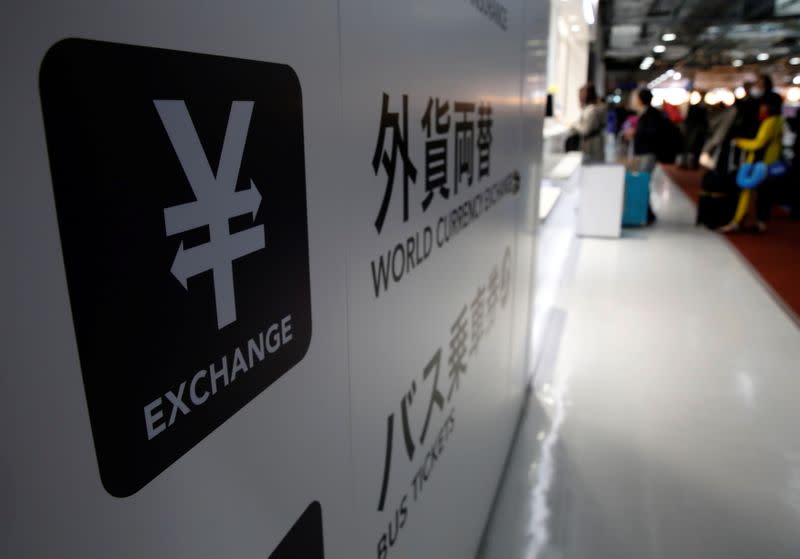 FILE PHOTO: A Japanese yen currency sign is seen at a currency exchange office as people line up to exchange money at Narita International airport