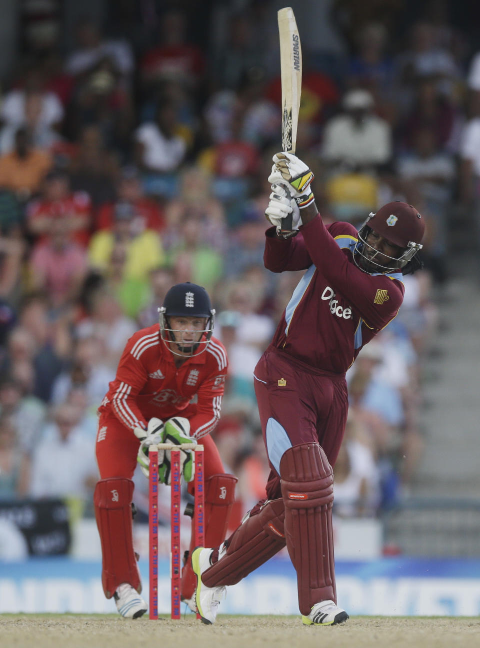 West Indies' Chris Gayle hits a six during the second T20 International cricket match against England at the Kensington Oval in Bridgetown, Barbados, Tuesday, March 11, 2014. (AP Photo/Ricardo Mazalan)