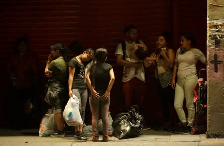 Central American migrants rest along the street after their return to Mexico from the U.S. under the Migrant Protection Protocol (MPP) to wait for their court hearing for asylum seeking, in Ciudad Juarez