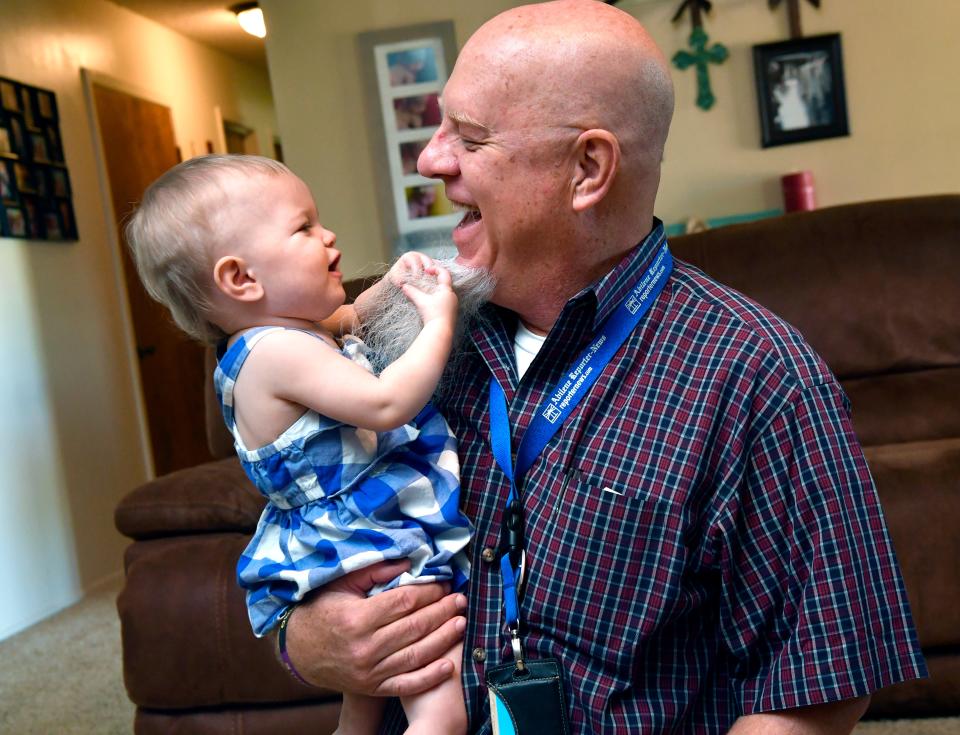 Auree Anders grabs a handful of beard hanging from the chin of Reporter-News Editor Greg Jaklewicz in July 2018. Auree was one of the quadruplets born to Tuscola's Meagan Anders a year earlier and Jaklewicz returned to the home for a follow-up story.