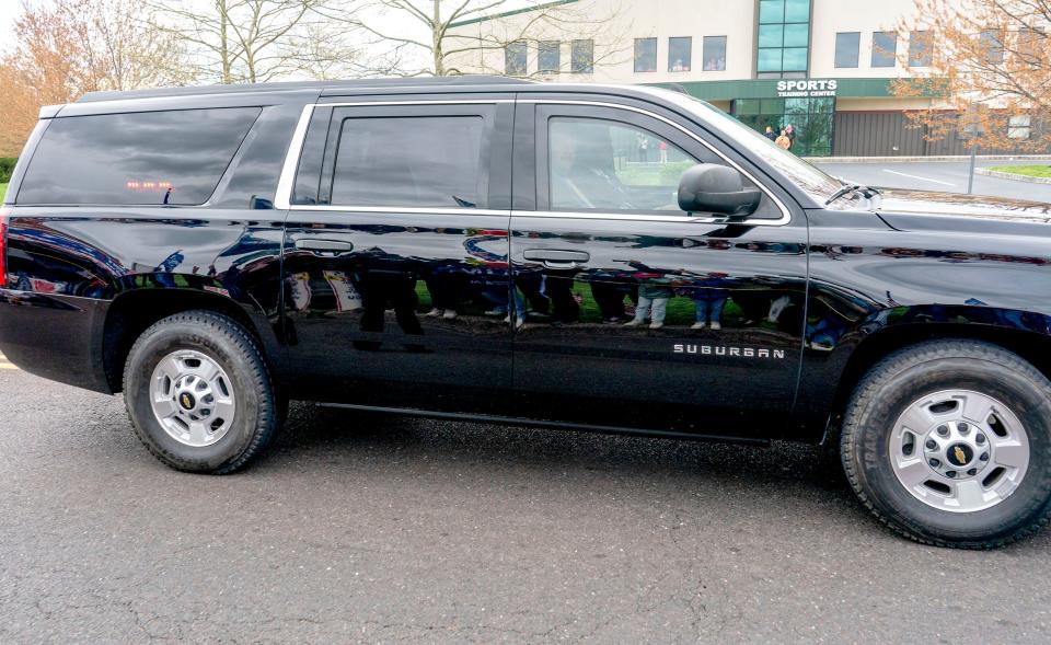 Supporters of former President Donald J. Trump reflected in an SUV a part of the former President's motorcade as it makes its way to the Newtown Athletic Club for a fundraiser in Newtown on Saturday, April 13, 2024.