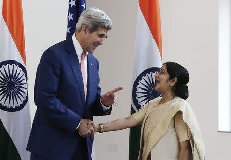 U.S. Secretary of State John Kerry (L) shakes hands with India's External Affairs Minister Sushma Swaraj before the start of their meeting in New Delhi, in this file photo taken July 31, 2014. REUTERS/Adnan Abidi/Files