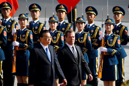 Chinese Premier Li Keqiang and Russian Prime Minister Dmitry Medvedev inspect the honour guard during a welcoming ceremony at the Great Hall of the People in Beijing, China November 1, 2017. REUTERS/Thomas Peter