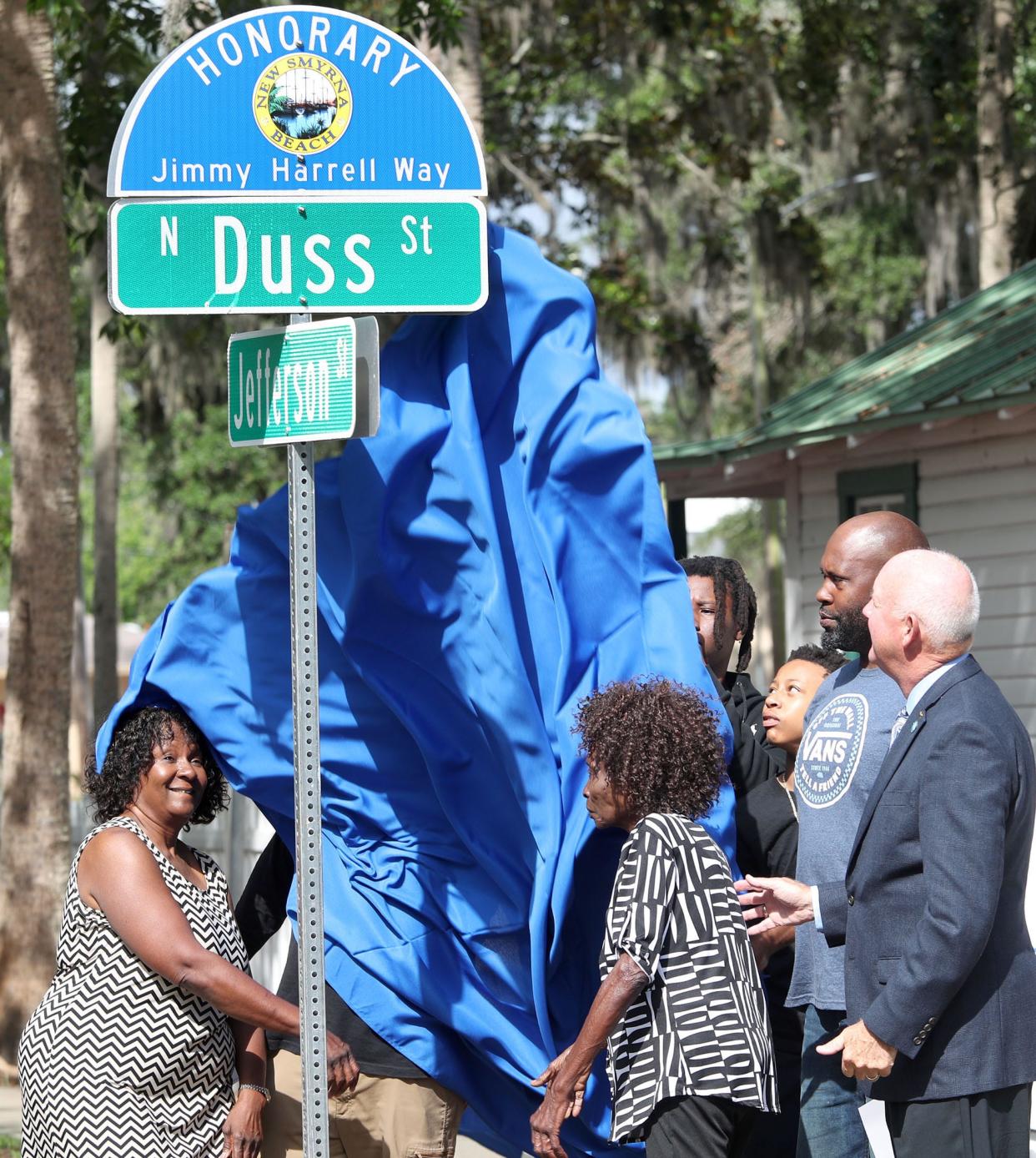 Harrell family members and New Smyrna Beach Mayor Fred Cleveland unveil the new street sign renaming Duss Street as Honorary Jimmy Harrell Way, Thursday, April 27, 2023, during a ceremony outside the Mary S. Harrell Black Heritage Museum in New Smyrna Beach.