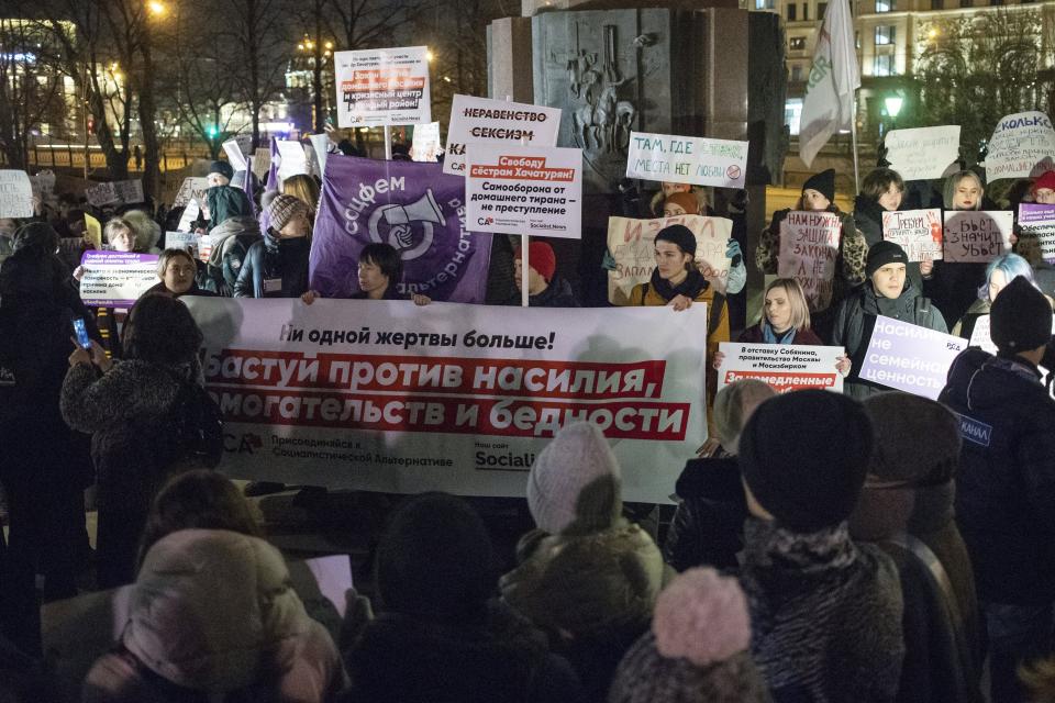 FILE In this file photo taken on Monday, Nov. 25, 2019, people hold banners against domestic violence as they attend a rally in Moscow's downtown, Russia. Russia's human rights ombudswoman says the number of domestic violence cases in the country grew 2 1/2 times during the lockdown he government ordered the population into a lockdown to stem the spread of the coronavirus. (AP Photo/Pavel Golovkin, File)