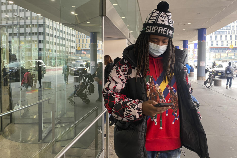 Frank Cope waits outside for a car after a checkup at Bellevue Hospital in New York on Wednesday, Jan. 3, 2023. The previous week, New York City resumed a mask mandate for the city’s 11 public hospitals. (AP Photo/Mary Conlon)