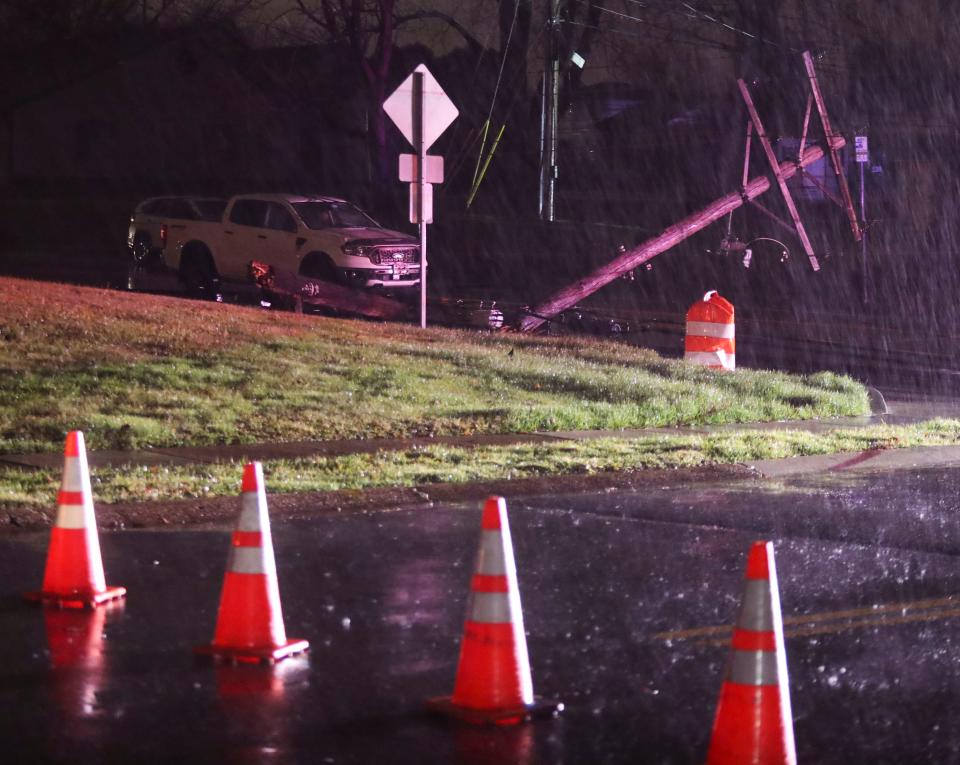 People wait in their vehicles after becoming trapped under live power lines along Milltown Road in Milltown after several utility poles were toppled as a powerful storm of wind and rain hit Delaware, Tuesday, Jan. 9, 2024. Firefighters and utility workers freed the occupants of two vehicles after more than one hour.