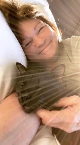 <p>wolfiesmeow/ Instagram</p> Valerie relaxes in bed with her cat Batman