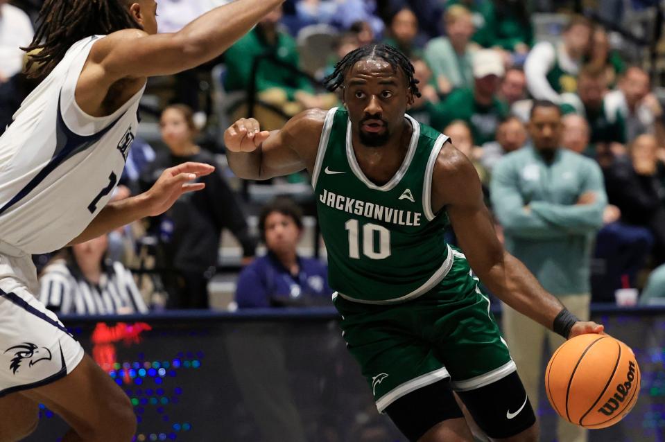 Jacksonville Dolphins guard Gyasi Powell (10) dribbles against North Florida Ospreys guard Chaz Lanier (2) during the first half of an NCAA men’s basketball game Friday, Jan. 12, 2024 at the University of North Florida’s UNF Arena in Jacksonville, Fla. UNF defeated JU 82-74. [Corey Perrine/Florida Times-Union]